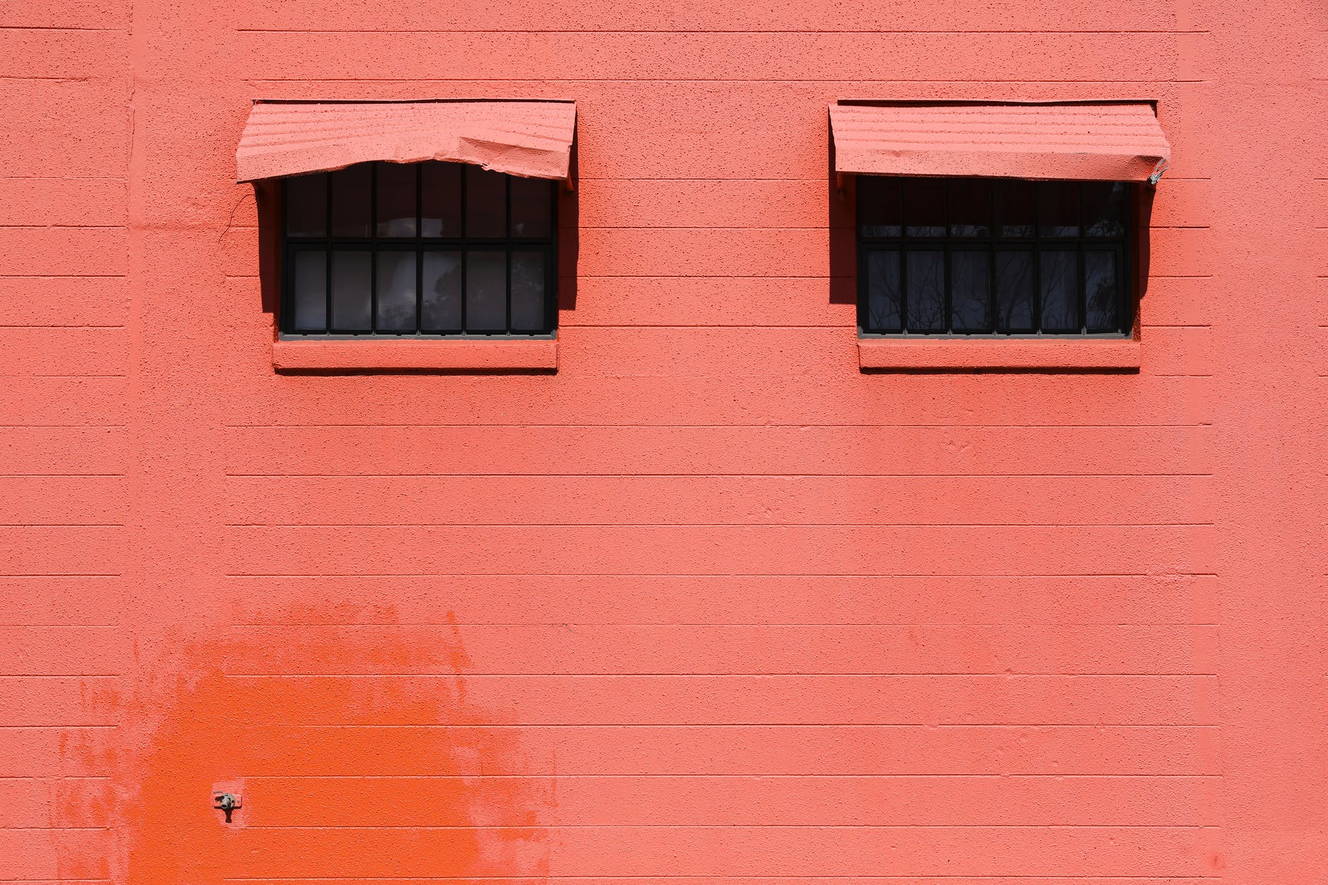 a pink wall with windows