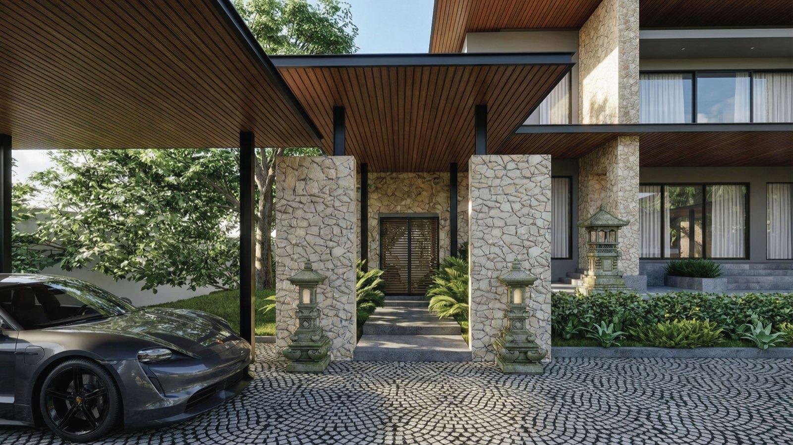 Entry canopy at Anyara Hill framed by stone piers and Balinese stone lanterns