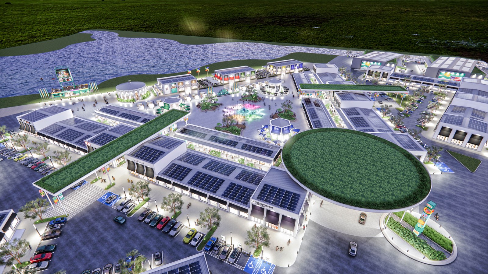 Night aerial of the PKNS Communal Hub masterplan beside the lake, showing green roofs, photovoltaic arrays and the plaza