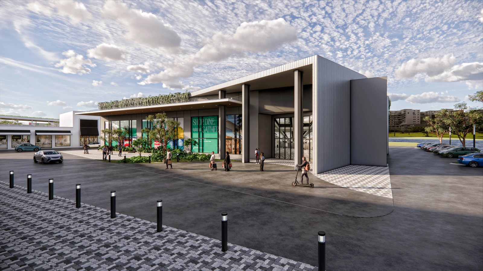 Main entrance portal at PKNS Communal Hub with a green roof edge and glazed shopfront