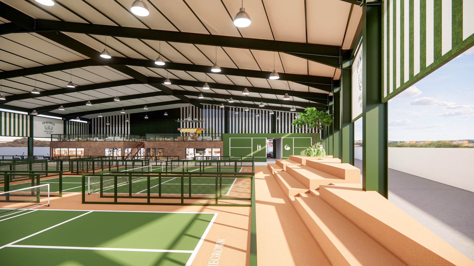 Four fenced pickleball courts under the green portal frame at PKNS Signature